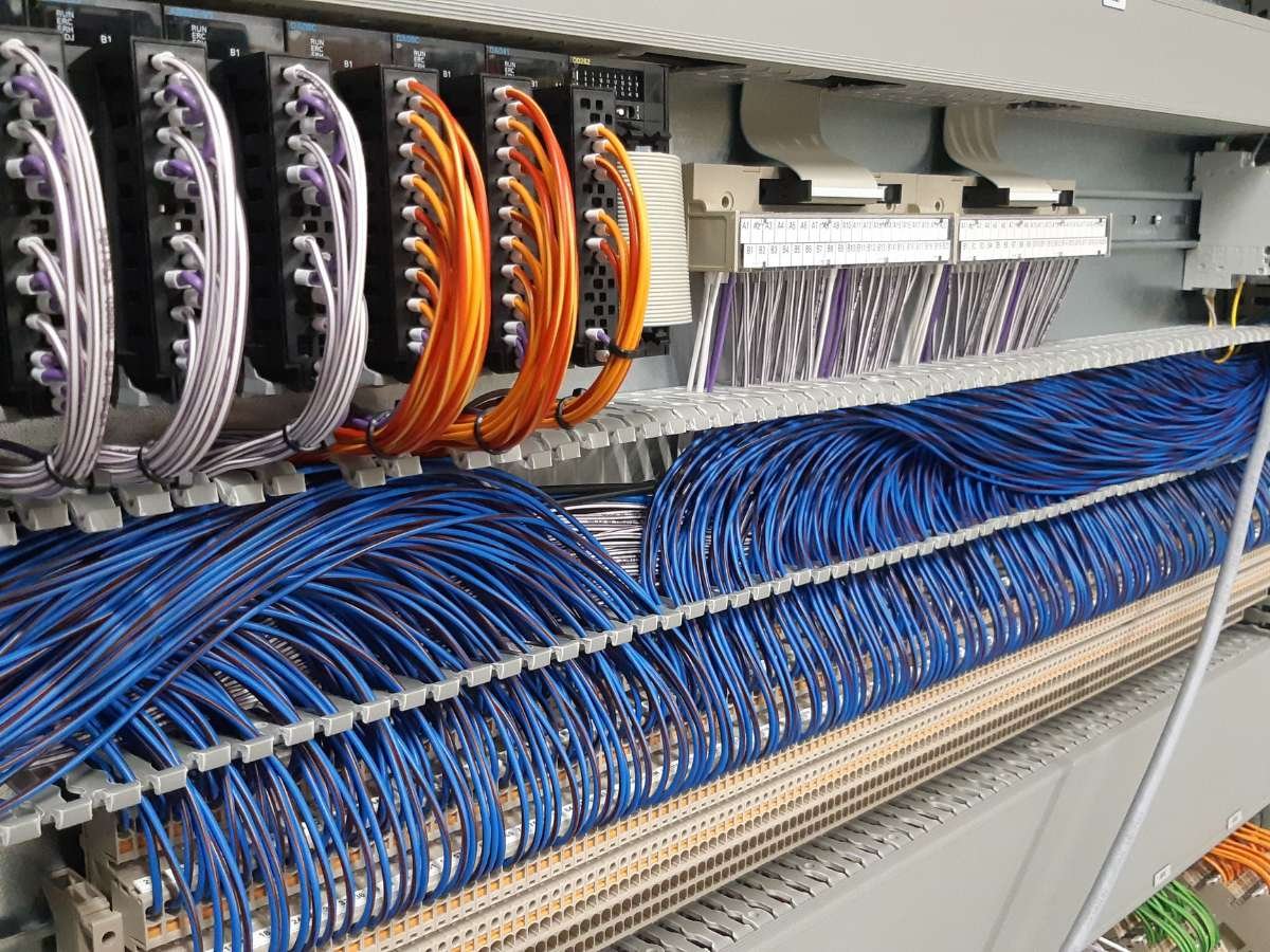 Geavanceerde PLC besturingseenheid met netjes weggewerkte gekleurde bedrading in kabelgoten.